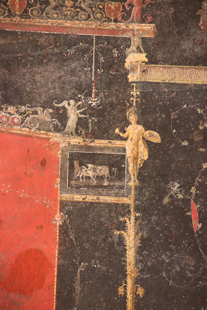 VI.15.1 Pompeii. October 2024.
Detail from top of left side of black painted panel with candelabra from east end of north wall.
Photo courtesy of Klaus Heese.