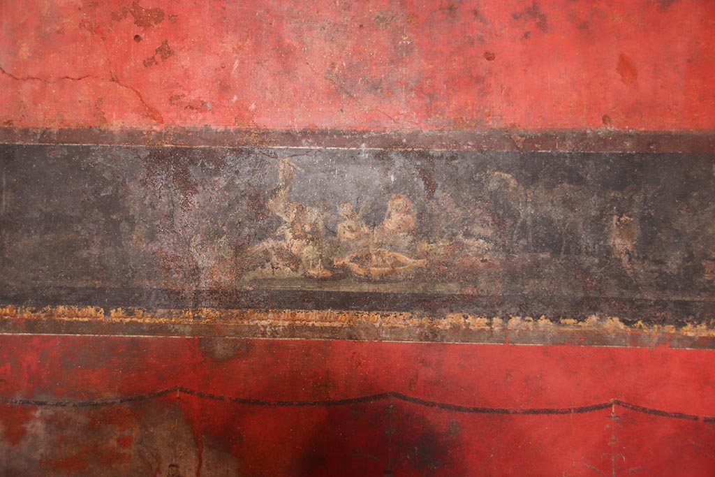 VI.15.1 Pompeii. October 2024. Detail from north wall, at east end, cupids celebrating the festival of Vesta. Photo courtesy of Klaus Heese.