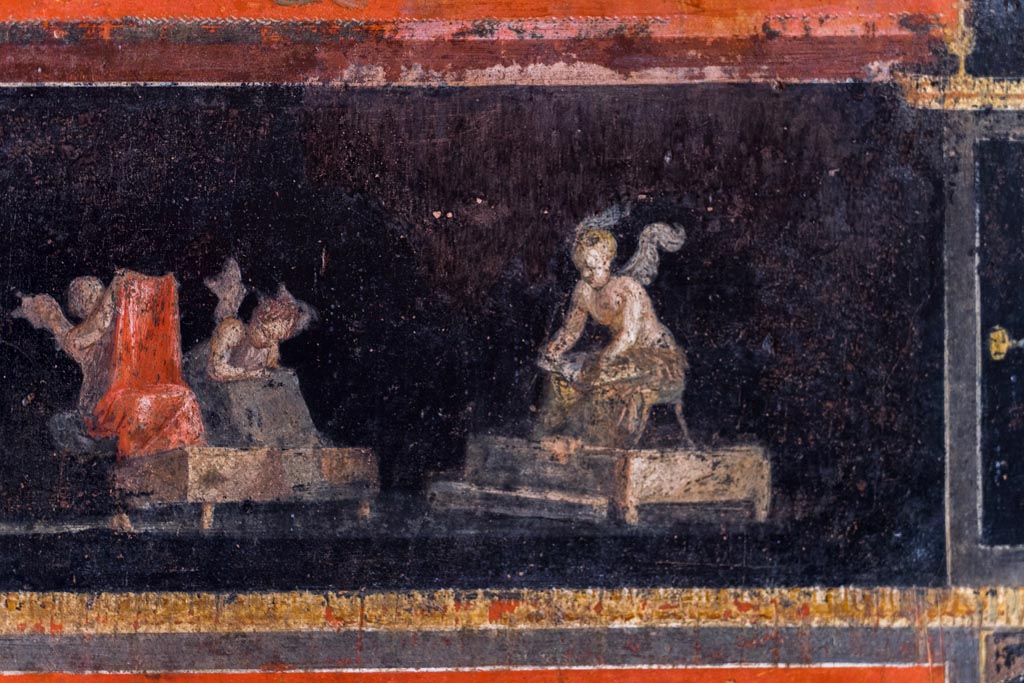 VI.15.1 Pompeii. March 2023.
Part of painted panel from east wall at north end of cupids cleaning clothes in a fullery. Photo courtesy of Johannes Eber.