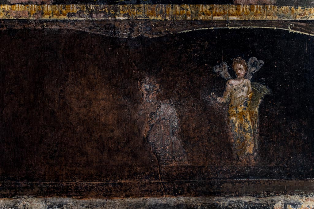 VI.15.1 Pompeii. March 2023.
Detail from panel from east wall at north end, above panel with painted female figure or priestess holding an implement of sacrifice.
Photo courtesy of Johannes Eber.