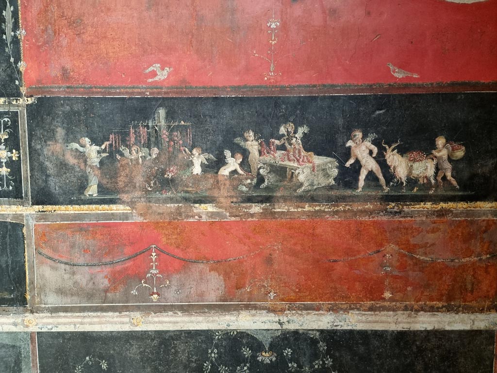 VI.15.1 Pompeii. December 2023.
Detail from east wall in the south-east corner with painting of cupids as flower dealers, picking and selling flowers and making garlands.
Photo courtesy of Miriam Colomer.