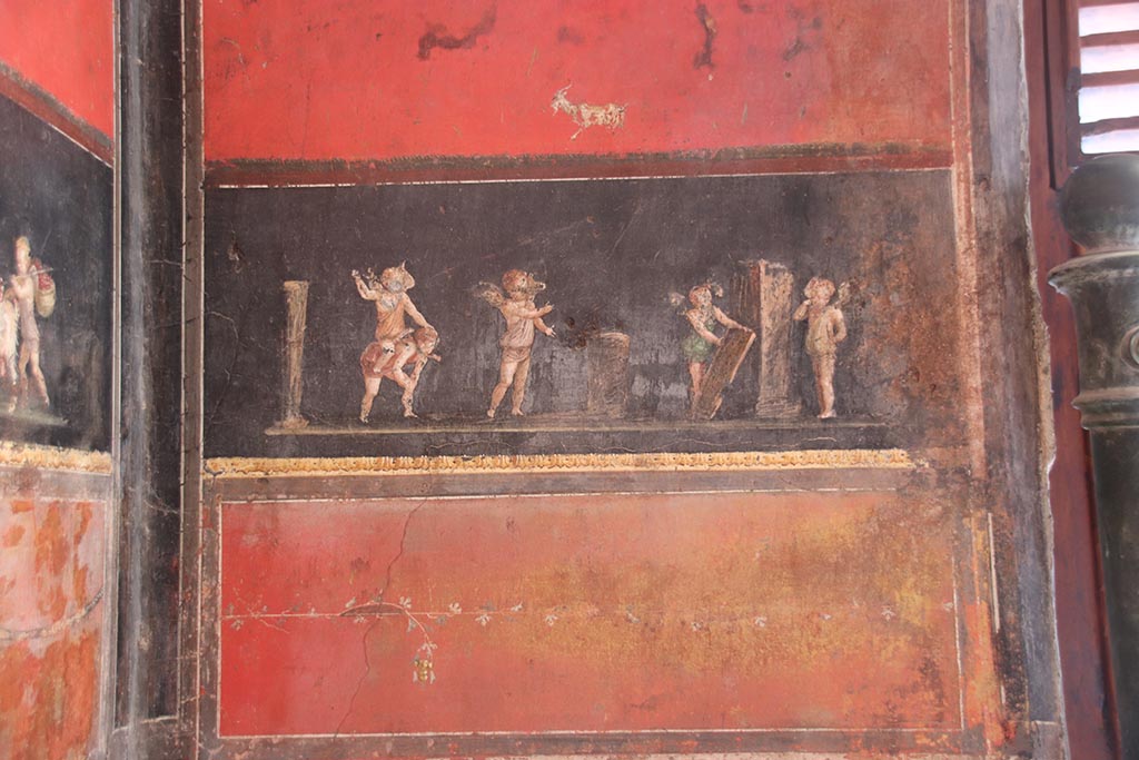 VI.15.1 Pompeii. October 2024.
South wall in south-east corner with painting of cupids taking part in an archery or throwing contest. Photo courtesy of Klaus Heese.