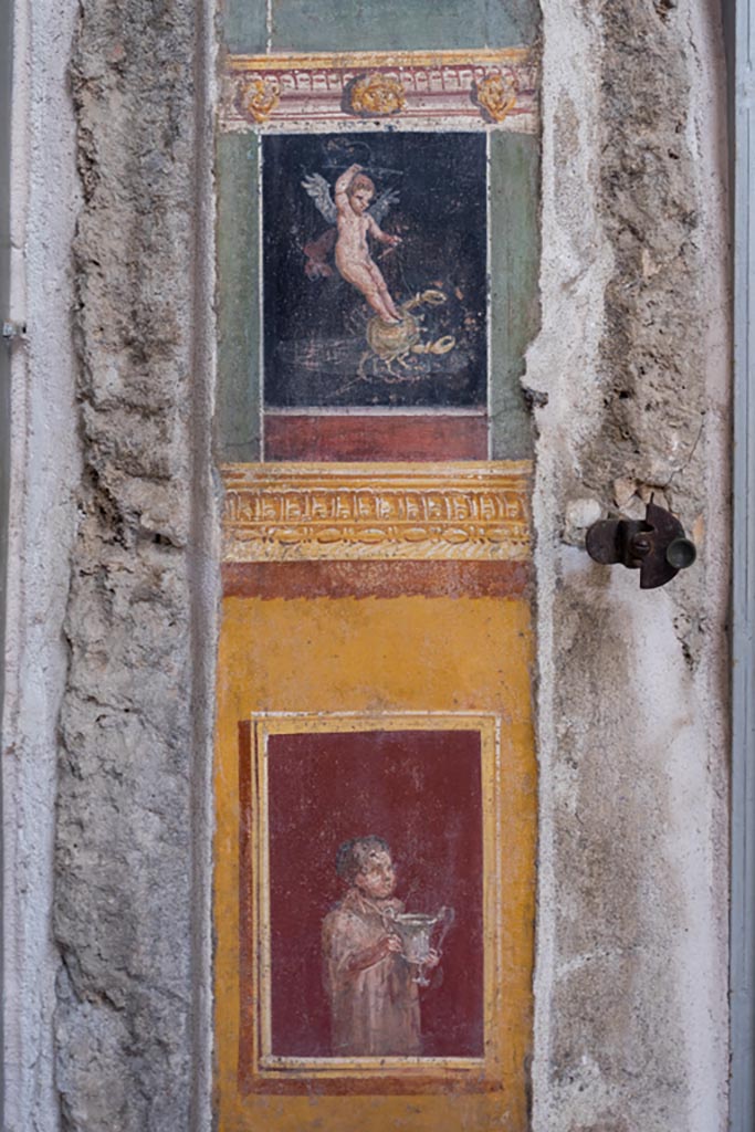 VI.15.1 Pompeii. March 2023.
Painted panel on south end of west wall of atrium, leading onto peristyle. Photo courtesy of Johannes Eber.