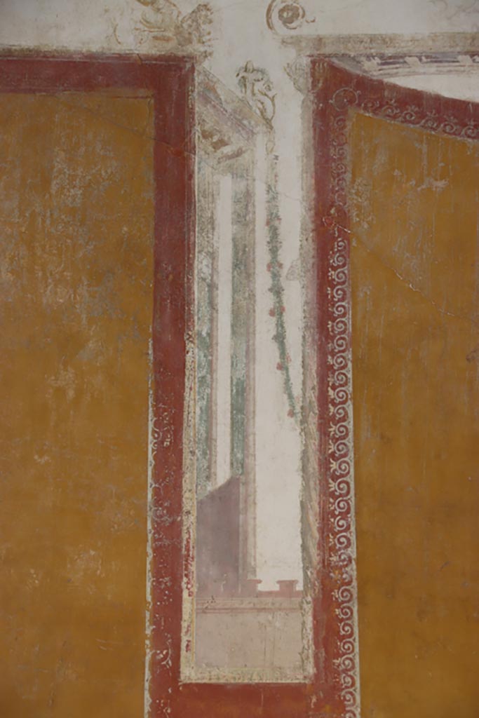 VI.15.1 Pompeii. October 2023.
Detail of architectural painting separating panels on south wall. Photo courtesy of Klaus Heese.
