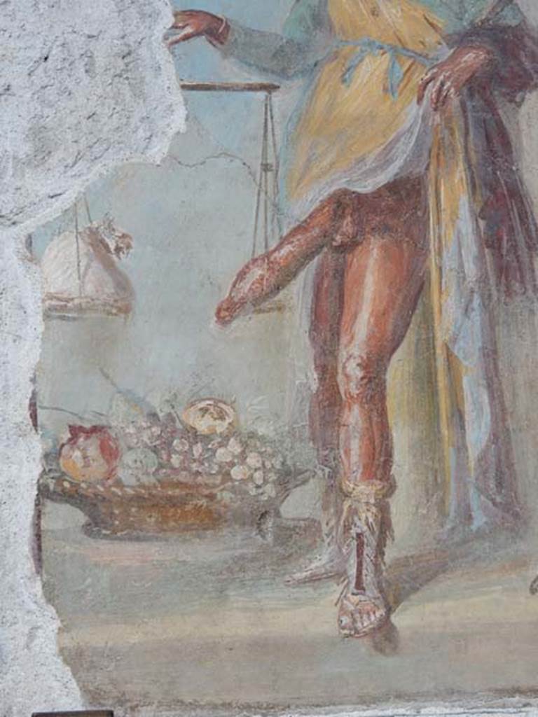 VI.15.1 Pompeii. May 2017. Detail from painting in vestibule, seeming to suggest good health is worth its weight in gold. A large basket of fruit represents the abundance of the house. Photo courtesy of Buzz Ferebee.