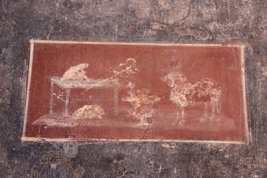 VI.15.1 Pompeii. October 2023. Detail of painted panel from north wall of vestibule at west end. Photo courtesy of Klaus Heese.