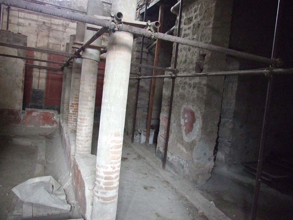 VI.15.1 Pompeii. December 2006. Gynaeceum, looking north-east.
This area has a small courtyard/peristyle “s”, a triclinium with black walls “t” and a large cubiculum with white walls “u”.
The triclinium is the first doorway on the right with the doorway to the cubiculum behind.
A doorway also links the cubiculum and the triclinium.
This area was partly ruined by the 1943 bombing.
The triclinium in the south-east corner of this area (on the right of the photo) was decorated with paintings.
On the south wall was a painting of Hercules and Auge, this was damaged in its lower parts and could not be restored.
See Garcia y Garcia, L., 2006. Danni di guerra a Pompei. Rome: L’Erma di Bretschneider. (p.93-96, including photos)
On the east wall was a painting of Achilles discovered on Skyros (Scyros), and paintings of floating figures were also seen.
See Richardson, L., 2000. A Catalog of Identifiable Figure Painters of Ancient Pompeii, Herculaneum. Baltimore: John Hopkins, p. 167.