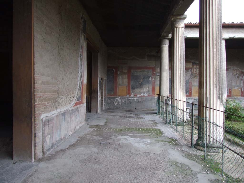 VI.15.1 Pompeii. December 2006. East side of peristyle, looking south.
The doorway on the left leads into the atrium, the next large doorway is to the Exedra in the SE of the peristyle, go to plan to view this room (PPM room - n).
The small doorway at the end of the east wall, is the doorway in the south-east corner of the peristyle. (PPM room – o).
