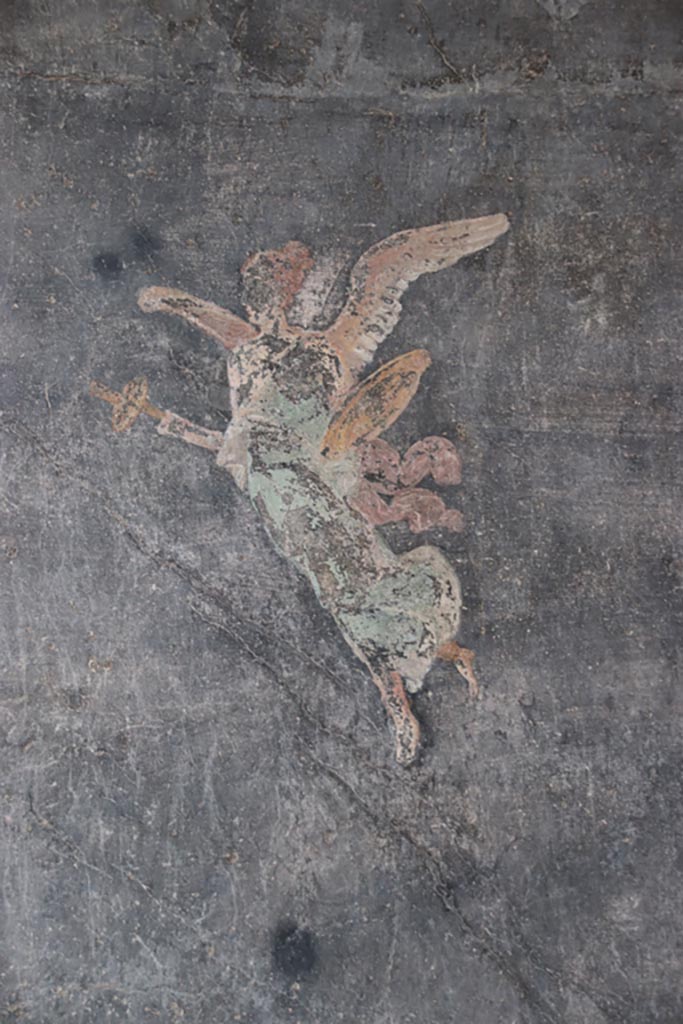 VI.15.1 Pompeii. October 2023.
Painted figure on south wall near south-west corner of peristyle. Photo courtesy of Klaus Heese.