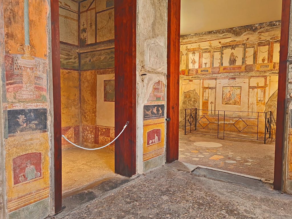VI.15.1 Pompeii. April 2023. Looking towards south-east corner of atrium.
Doorway into cubiculum (d) on left, and into oecus (e), on right. Photo courtesy of Giuseppe Ciaramella.