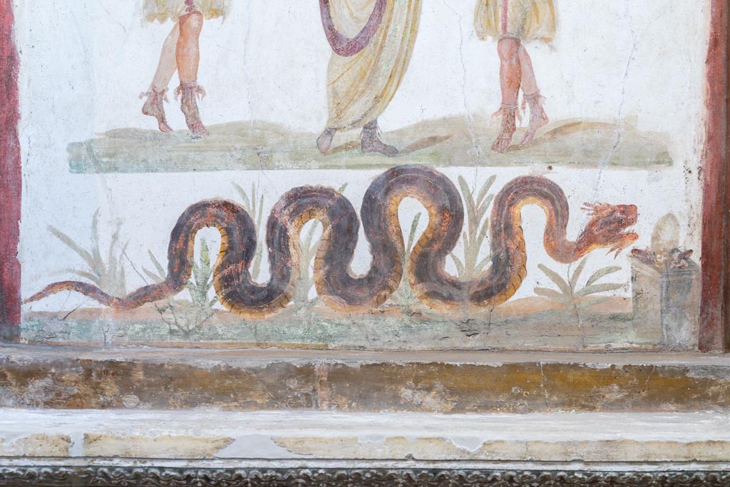 VI.15.1 Pompeii. March 2023. Serpent on lararium painting gliding through plants towards altar. Photo courtesy of Johannes Eber.