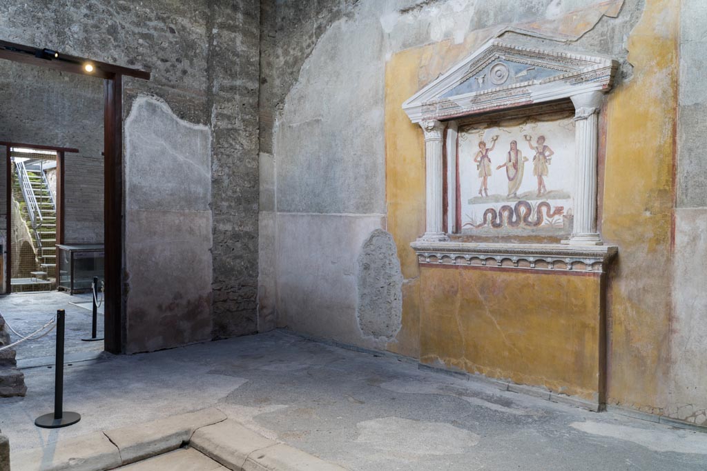 VI.15.1 Pompeii. March 2023.
Looking across impluvium in services area towards lararium on west wall, and doorway to atrium in south wall.
Photo courtesy of Johannes Eber.