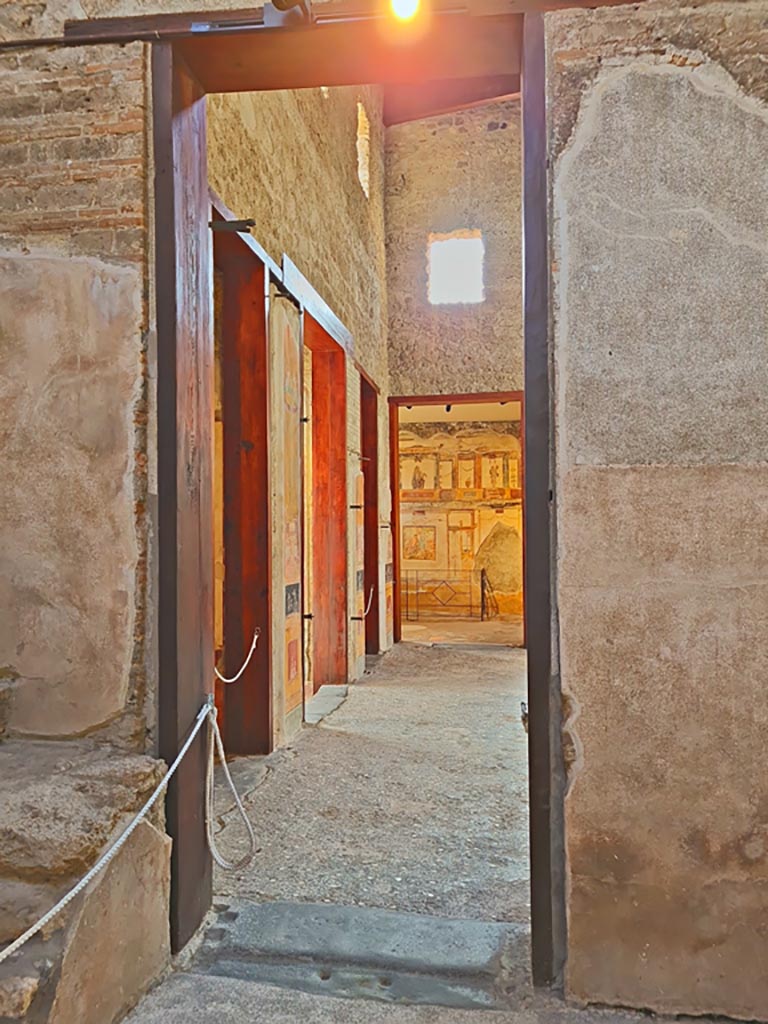 VI.15.1 Pompeii. April 2023.
Looking south through doorway from services’ area into atrium. Photo courtesy of Giuseppe Ciaramella.