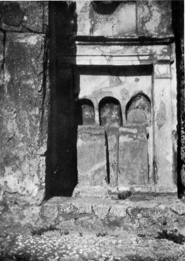 VI.15.5 Pompeii. 1930s photo by Tatiana Warscher. Room 1, atrium.
Altar on east wall of the atrium composed of three arched niches, all of different sizes, and all three painted in red on the inside.
See Boyce G. K., 1937. Corpus of the Lararia of Pompeii. Rome: MAAR 14. (p. 54-5, no.212, with Pl. 40, 1)