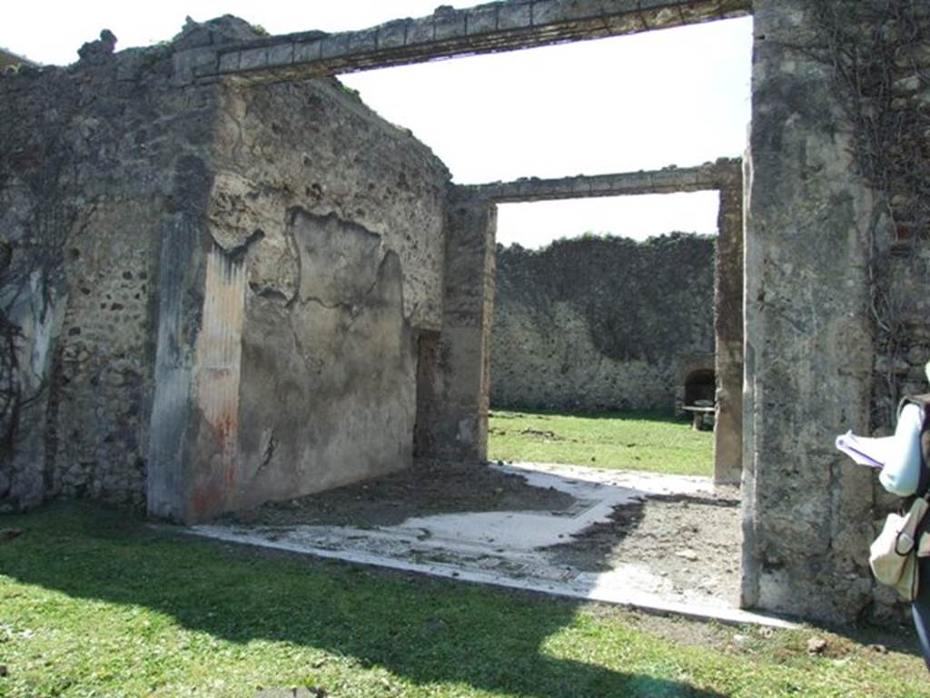 VI.15.5 Pompeii. March 2009. Room 7, south wall of tablinum, looking west. According to NdS, opposite the entrance doorway was the tablinum, with a good mosaic floor. In the middle of the floor was the usual rectangle indicating that this tablinum was also used as a triclinium. It was devoid of decoration, but there were some remains of the oldest decoration such as in the walls and doorposts, covered in grooved stucco, and with a red dado. See Notizie degli Scavi, January 1897, (p.23)