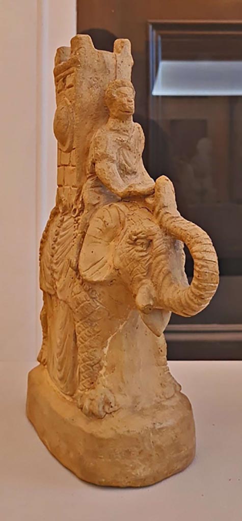 VI.15.5 Pompeii. October 2023.
Clay figurine of an elephant carrying a tower on its back.
Photo courtesy of Giuseppe Ciaramella.
On display in “L’altra MANN” exhibition, October 2023, at Naples Archaeological Museum.