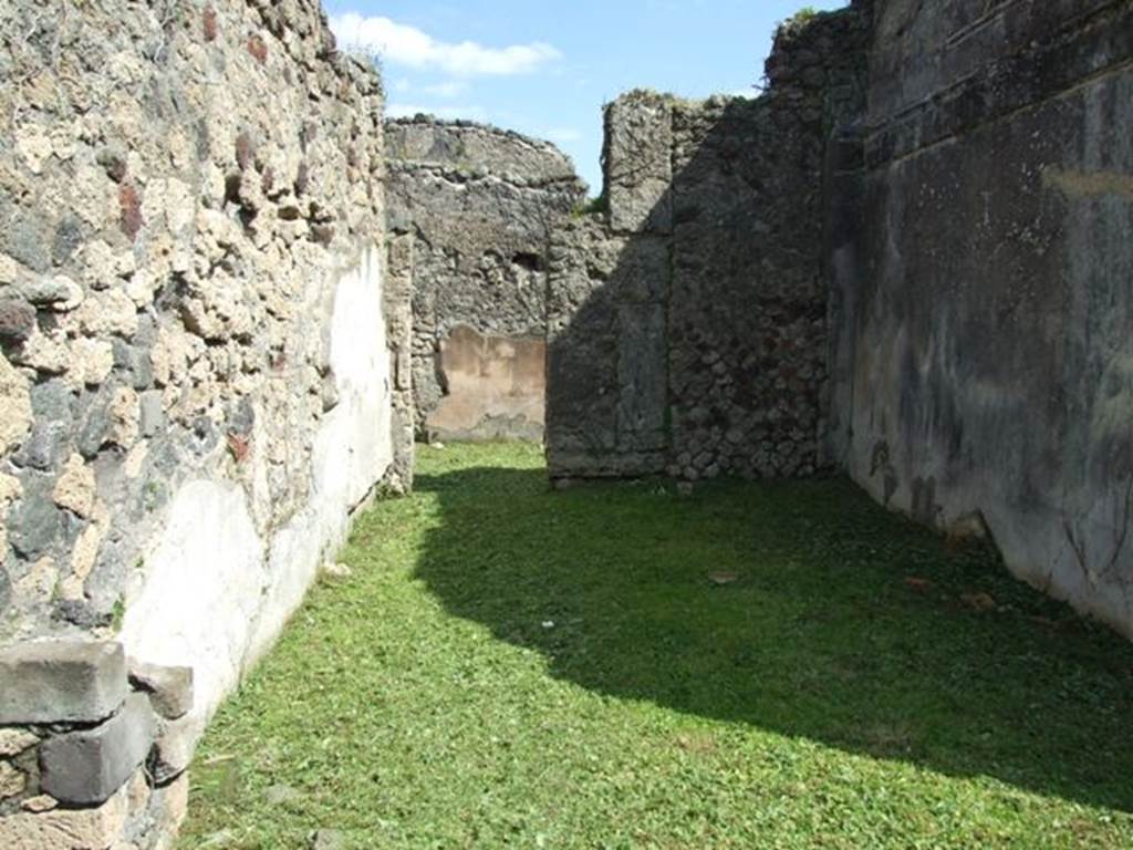 VI.15.5 Pompeii. March 2009. Room 24, oecus. Looking east to wall with doorway into room 6, ala. According to NdS, originally this room may have been a cubiculum, in the north wall was the recess for a bed. However, following the renovation of the house and the opening into the ala, this room was probably not a cubiculum, since the bed would have blocked the new doorway. See Notizie degli Scavi, January 1897, (p.27)
