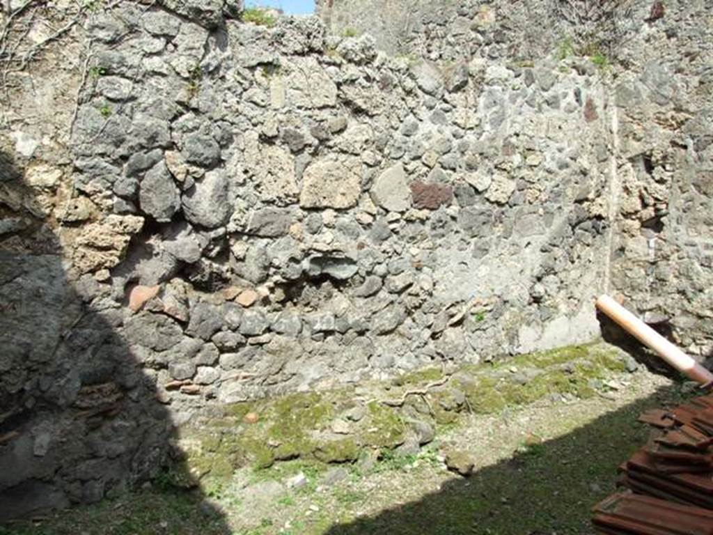 VI.15.6 Pompeii. March 2009. Room 11. Storeroom. North wall and north west corner, with remains of bench?.