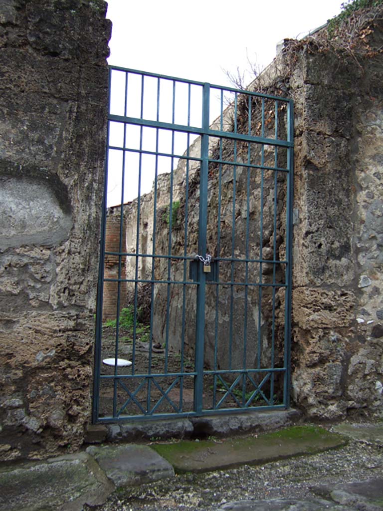 VI.15.6 Pompeii. December 2005. Entrance doorway, looking west.
According to NdS, this doorway led into a modest house.
The entrance doorway had limestone doorjambs. The fauces, or entrance corridor, preserved remains of coarse plaster.
Above the threshold of the doorway, the usual holes in the walls for the beam that would have strengthened the door when it was closed, could be seen.
See Notizie degli Scavi di Antichità, January 1897, (p.30).