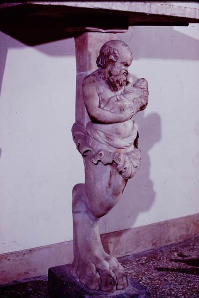 VI.15.8 Pompeii, 1978. Marble table top, with foot in the shape of a lion’s paw, found in the garden area. At the top of the leg were acanthus leaves from which emerged the bust of Silenus with the baby Bacchus on his left arm. Photo by Stanley A. Jashemski.
Source: The Wilhelmina and Stanley A. Jashemski archive in the University of Maryland Library, Special Collections (See collection page) and made available under the Creative Commons Attribution-Non Commercial License v.4. See Licence and use details. J78f0577