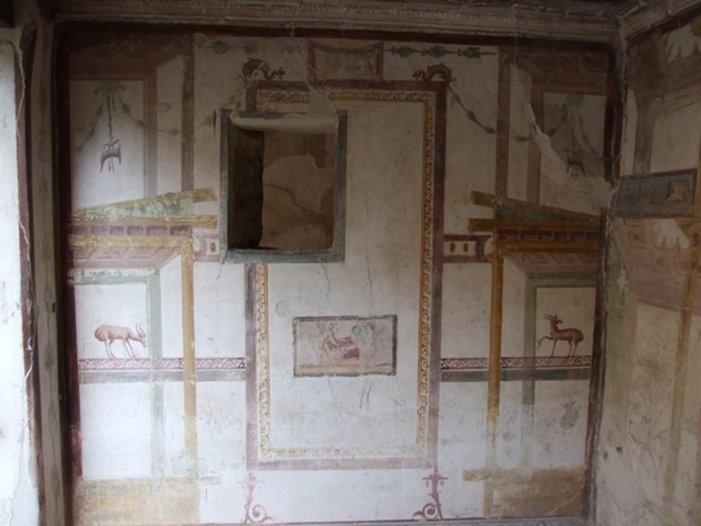 VI.15.8 Pompeii. December 2007. East wall of summer triclinium, with small window onto small recess or cupboard. According to NdS, in the centre on the east wall was a small painting showing cupids taking objects from a small box for the toilette of Venus: the one on the right was already holding a circular mirror, the other on the left was, perhaps, taking out a jewel? See Notizie degli Scavi, January 1897, (p.38)