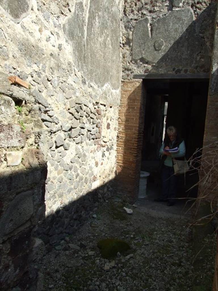 VI.15.9 Pompeii. March 2009. Roofless kitchen area looking east, walls with no holes for an upper floor.