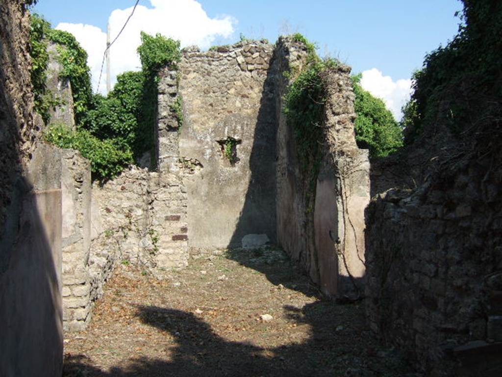 VI.15.22 Pompeii. September 2005. Looking east towards tablinum, with window. According to NdS, this small house had walls coated with rustic plaster, with a high dado of brick plaster (mattone pesto). On entering the house, on the right, was the kitchen.
On the extreme lower right of the above photo would be the stairs to the upper floor.
The perfectly preserved remains of an upstairs latrine were discovered on the upper floor.
The doorway in the wall on the right leads to a room where a human skeleton was found on 26th June 1897. Opposite the doorway, on the left, was a small garden. The doorway on the left leads into a room, the triclinium, with a window onto the garden. See Notizie degli Scavi, June 1897, (p.272-3)
Another human skeleton was reportedly found in a room on the south side of the atrium on 17th June 1899. See Notizie degli Scavi, June 1899, (p.235)
According to Hobson, there were two upper storey latrines discovered in Reg. VI, one in VI.15.20, the other here in VI.15.22. See Hobson, B., 2009. Latrinae et foricae: Toilets in the Roman World. London; Duckworth. (p.75)