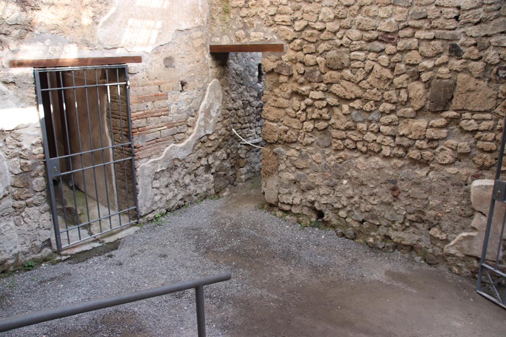 VI.15.27 Pompeii. October 2023.
Looking north-east from steps towards corridor to atrium, on left, and doorway to stable, in centre. Photo courtesy of Klaus Heese.