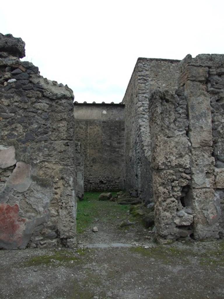 VI.16.5 Pompeii. December 2007. Entrance doorway, looking west. The lava threshold can now be seen in the shop entrance doorway. The small wall between the shop room and rear room has been knocked down.