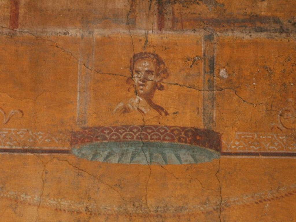 VI.16.7 Pompeii. December 2004. Room N, painting of face on south end of east wall.