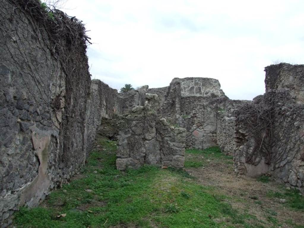 VI.16.11 Pompeii. December 2007. Looking west to room in north-west corner of shop and corridor to rear in south-west corner.