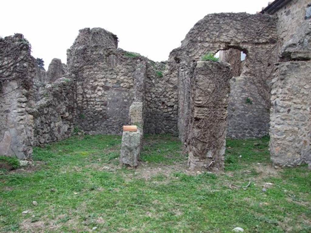 VI.16.13 Pompeii. December 2007. Doorways to three rooms on west side. According to NdS, the room on the left was a small room with opus signinum floor. It was lit by a circular window in the top of the west wall. At the foot of this same west wall, on the floor and also on the sidewalls, one could see the trace left by a very long rectangular form of wooden furniture, that occupied all the lower space from one wall to the other. The room in the centre was a type of small corridor, that received its light from a slit at the top of the west wall. The room on the right had a floor of cocciopesto and walls faced with rough plaster.
In its western wall was a rectangular window and above it the holes for the beams that supported the upper room. Part of the upper room’s west wall still existed, a continuation of that of the room below, with the remains of the painted decoration, consisting of a panel with a white background, showing the representation of a sea-monster preserved by its serpentine tail, and some small dolphins. See Notizie degli Scavi di Antichità, 1908, (p.63)