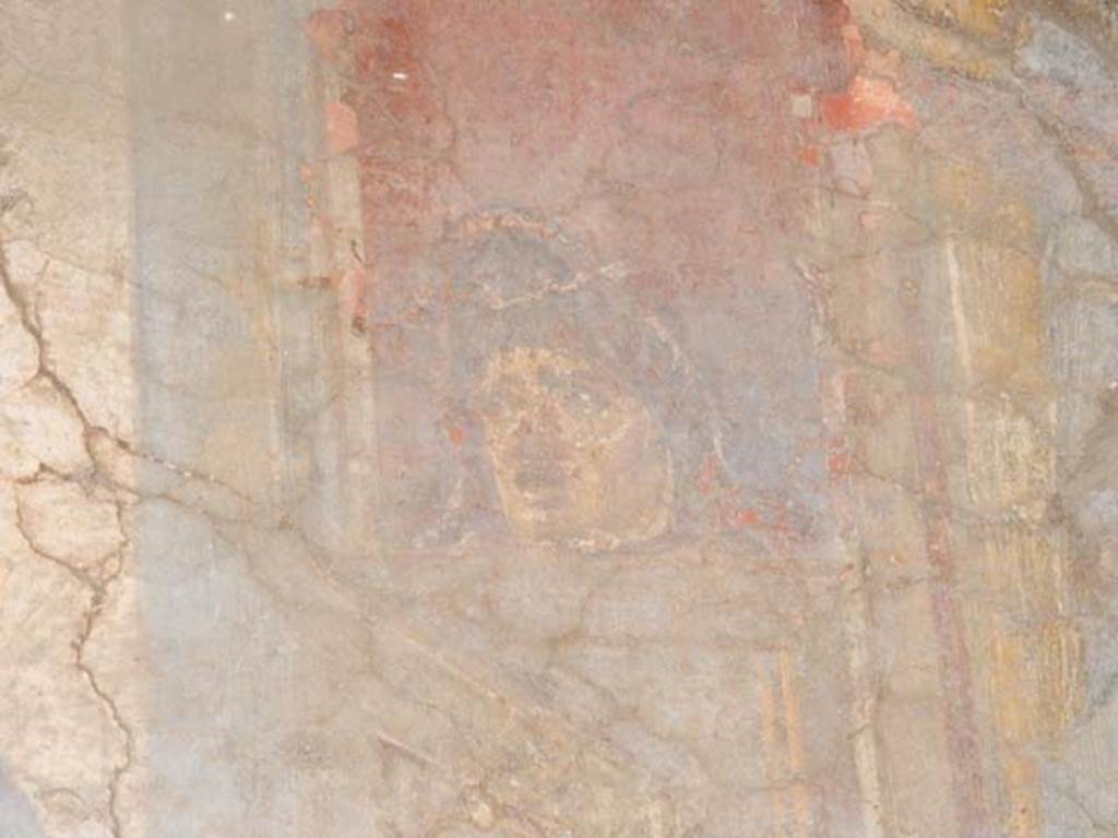 VI.16.15 Pompeii. May 2015. Detail of mask from north end of upper west wall of atrium B above room E. Photo courtesy of Buzz Ferebee.