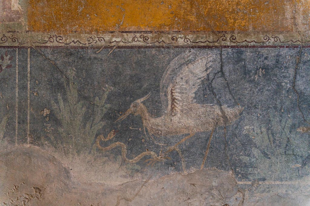 VI.16.15 Pompeii. January 2024.
Room F, centre of zoccolo of lower west wall with painting of bird, serpent and plants. Photo courtesy of Johannes Eber.