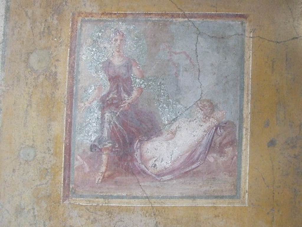 VI.16.15 Pompeii. December 2006. Wall painting of The Sleeping Ariadne from the centre of the east wall of room F. On the right Ariadne sleeps with her back to the spectators, near to her was a Bacchante. She was nude except for a peacock-blue mantle covering the lower part of her body. Around her arm was a large golden armband. From the left arrived a Bacchante carrying a thyrsus in the left arm. See Notizie degli Scavi, 1908, (p.71-2)