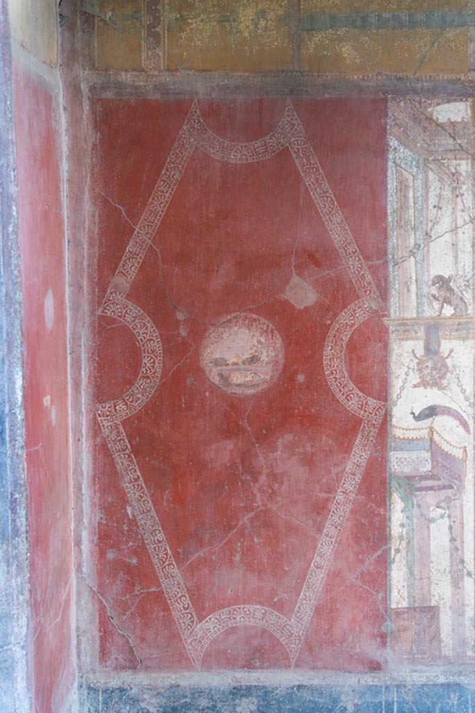 VI.16.15 Pompeii. January 2024.
Room F, east wall at north end, painted red panel with medallion Photo courtesy of Johannes Eber.