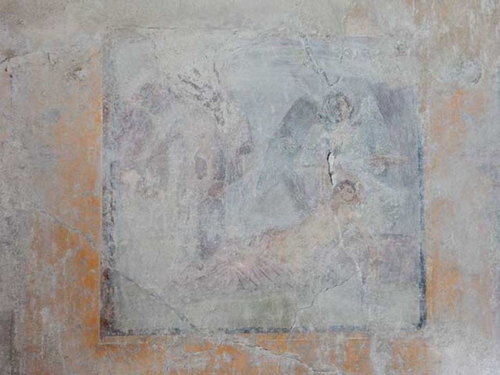 VI.16.15 Pompeii. May 2015.
West wall of room G with central wall painting of the arrival of Dionysus on Naxos where Ariadne is sleeping. Photo courtesy of Buzz Ferebee.
Kuivalainen describes –
“A composition of at least six figures; the two on the right are in an arching cave-like space, marked with dark brown. In the foreground, a female reclining to the right, raises her right arm to the top of her head as if awakening; a pink cloak covers her legs. Behind her stands a figure with green wings, dressed in a green robe, holding branches in her right hand and a large patera in her left. On the left side of the picture stands a youth stretching his right arm to the left, with a red cloak covering his left shoulder; in his left hand he holds a thyrsus. Behind are members of the thiasus, perhaps with Silenus on the left.”
Kuivalainen comments –
“Another version of the same theme, but Bacchus now seems to be paying less attention to the awakening Ariadne.”
See Kuivalainen, I., 2021. The Portrayal of Pompeian Bacchus. Commentationes Humanarum Litterarum 140. Helsinki: Finnish Society of Sciences and Letters, (p.148, E10).