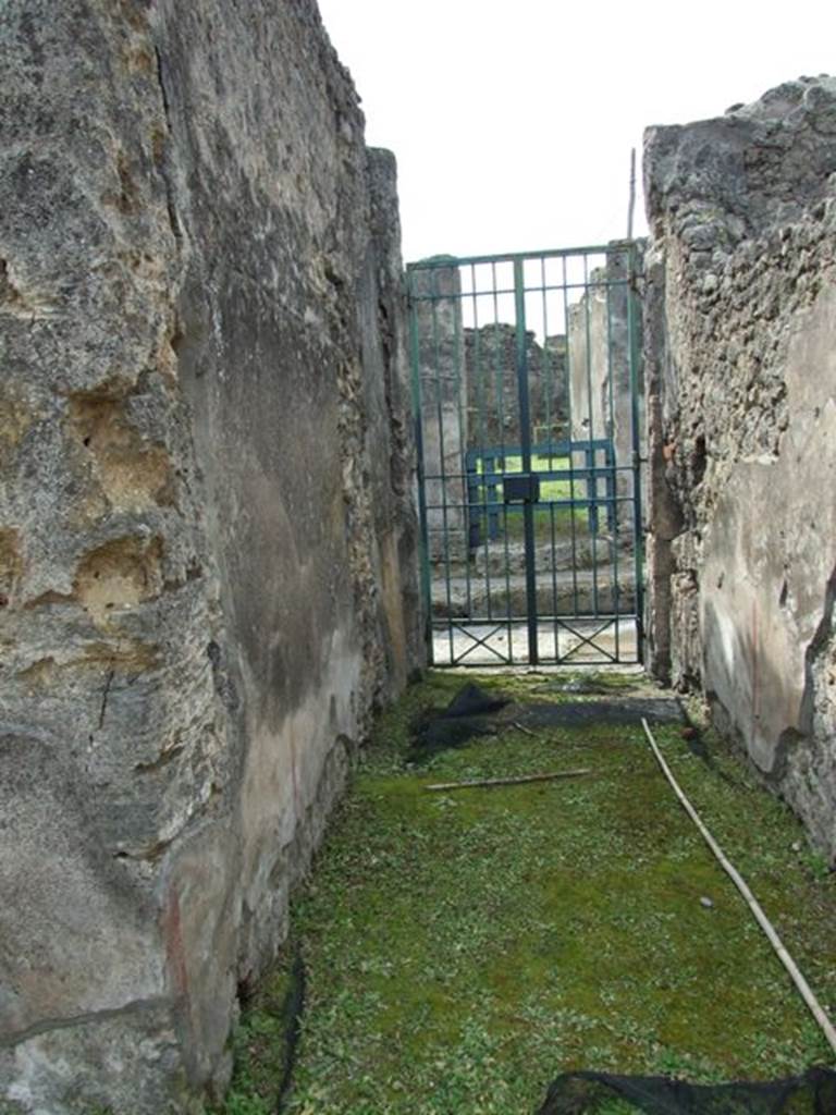 VI.16.27 Pompeii. March 2009. Room A, entrance corridor or fauces of VI.16.26. Looking west to Vicolo dei Vettii. According to NdS, this floor was made of opus signinum and sloped slightly upwards from the doorway. The walls had a high dado of plaster imitating a coarse decoration of marble, and above it was a simple rough plaster.