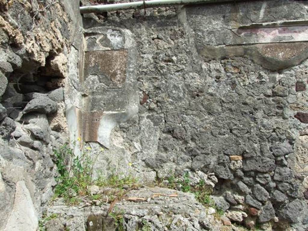 VI.16.27 Pompeii. March 2009. Room F, remains of decoration and painted plaster on east wal labove staircase.
