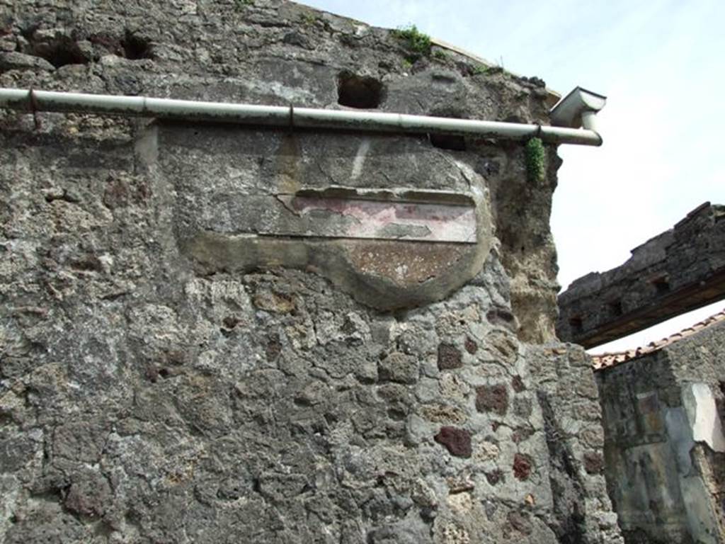 VI.16.27 Pompeii. March 2009. Room F, remains of decoration and painted plaster on east wall above staircase.