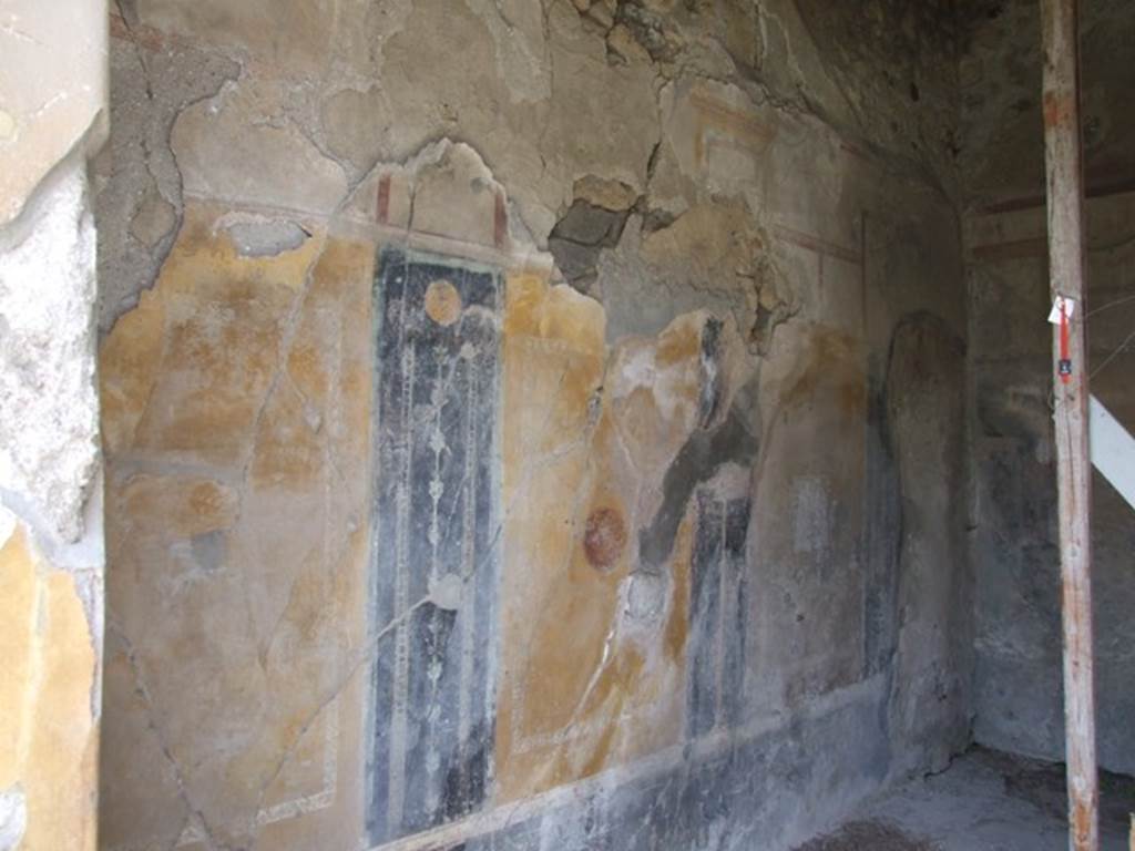 VI.16.27 Pompeii. March 2009. Room G, west wall of triclinium. According to NdS, the western wall had four panels, but the one on the right was missing. In the centre of each panel were - starting from the left, a flying griffin, next was a flying swan in a medallion.
In the third panel was a picture (0.32m high x 0.31 wide) but very faded. Here could be seen a male figure sitting on the left, with his left arm resting on the back of a seat. His right arm held up towards the left. It could be Ganimede beckoning to the eagle who descends from above. On both sides of the entrance doorway was a panel, each one with a tragic mask in the middle. See Notizie degli Scavi, 1908 (p.187)