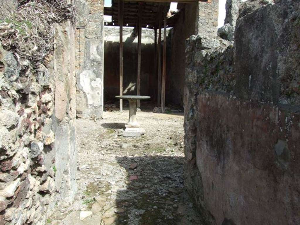 VI.16.28 Pompeii. March 2009. Looking east across atrium C, from entrance fauces A.
According to NdS, from the fauces you entered the rectangular atrium, rectangular from north to south. The floor was the same as the fauces, and so too were the painted walls, except for the higher dado. In the middle was the impluvium (a) which was coated with brick plaster, with pieces of slabs of marble buried in the base, without forming a design. Next to the eastern side of the impluvium a cartibulum was placed, consisting of a circular marble table supported by a leg of travertine. At the foot of the south wall of the atrium, there was a low masonry hearth.