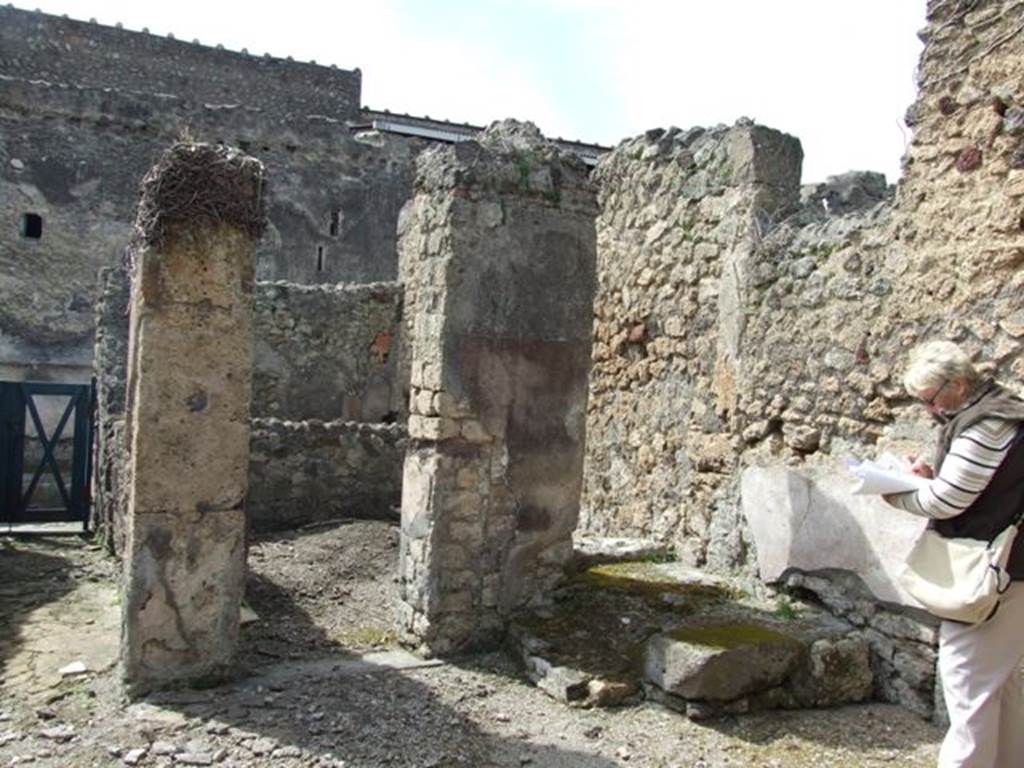 VI.16.28 Pompeii. March 2009. North-west corner of room C, atrium, with doorway to room E, room with stairs (d). According to NdS, in the north-west corner of the atrium was the beginning of a masonry step, for a wooden staircase.