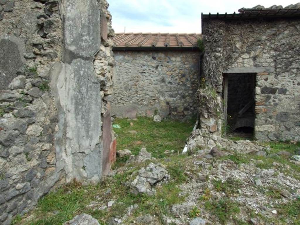 VI.16.29 Pompeii. March 2009. Doorway to room H, triclinium, in north-east corner of atrium. In front of the two doorways, the rubble would have been the site of the east wall of the atrium.
According to NdS, in the east wall of the atrium was a large window, with a doorway on either side of it. The doorway on the north opened into rectangular room H.
The floor was of cocciopesto. In the right end of the south wall of room H was a doorway that led into the area behind the window, room I. From room I, the other doorway on the south side of the window led back into the atrium.
According to Giacobello, the doorway and wall on the east side of the atrium containing two niches collapsed following the 1980 earthquake. Today, of the two arched niches only the one on the left has been partially conserved. They would have been a short distance away from each other, and plastered inside in white stucco. See Giacobello, F., 2008. Larari Pompeiani: Iconografia e culto dei Lari in ambito domestico. Milano: LED Edizioni. (p.243)