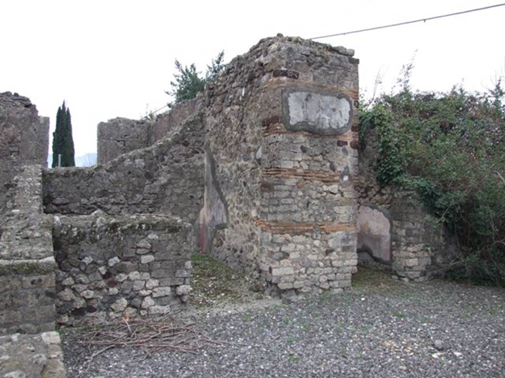 VI.17.10 Pompeii. December 2007. South side of atrium from entrance. Looking towards doorways of two of the three cubicula.
According to Allroggen-Bedel – In the room next to the Ala, right from room No.10 (doorway on right of photo), there is no depression for the bed. In the room on the left (from room No.10), next to the steps, you can still see the remains of a red zoccolo, and a yellow middle zone. The remains of these decorations agree with La Vega description of room No.13 –
“From the 9th to the 18th December, we excavated the indicated small room. The floor was of slabs of crushed brick (lastrico di mattoni pesto). In the plaster the zoccolo has the red background: the bottom of the panels that lay above the zoccolo was yellow with some birds in the middle; the bands that divided these squares were red, embellished with grotesque architecture, which still adorned the decoration above that had a white background.”