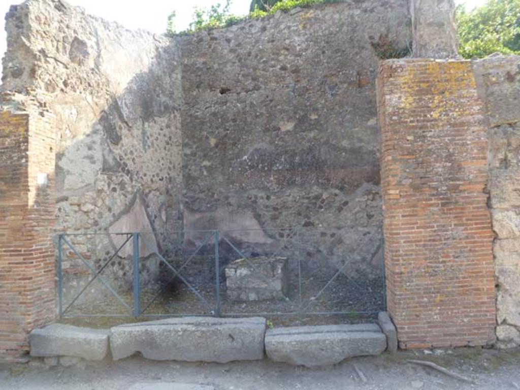 VI.17.19 Pompeii. May 2011. Looking west to entrance doorway, and brick podium at rear near west wall. Photo courtesy of Michael Binns.