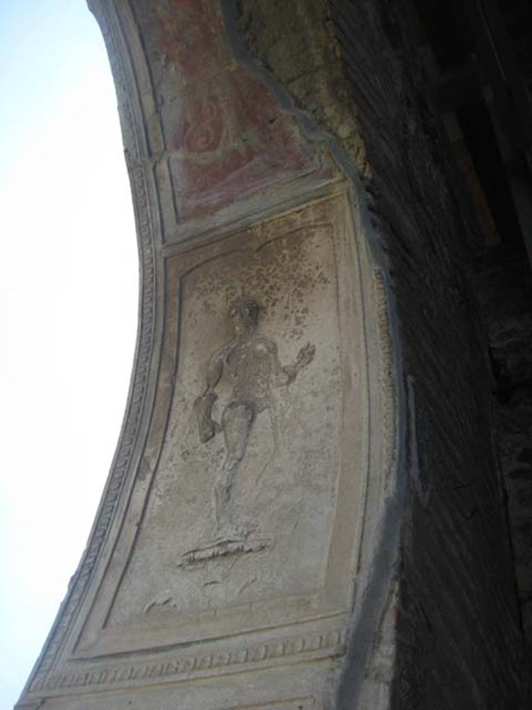 VII.1.8 Pompeii. July 2012. Nymphaeum F, east wall. Detail of decorative stucco plasterwork figure on south side of arch. Photo courtesy of Sharon M. Wolf.