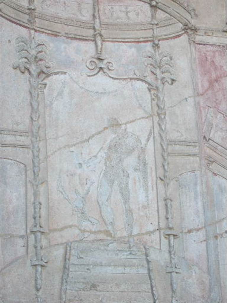 VII.1.8 Pompeii. September 2005. Stucco plaster on wall in south-west corner of gymnasium C. According to Mau, this may be a relief of a satyr offering Hercules a drinking horn. See Mau, A., 1907, translated by Kelsey F. W. Pompeii: Its Life and Art. New York: Macmillan, p. 197.