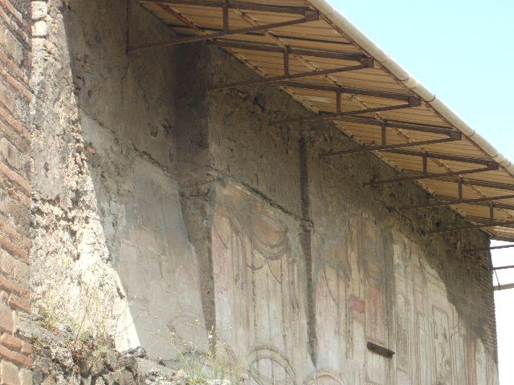 VII.1.8 Pompeii. September 2005. Plaster on wall in south-west corner of gymnasium C.
