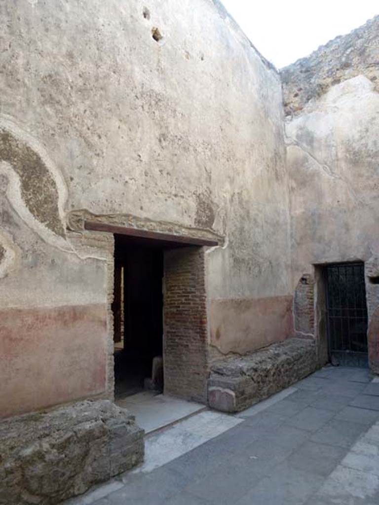 VII.1.14 Pompeii. June 2012. Looking north-west across waiting room 2a of Stabian baths. The doorway in the centre leads into the men’s changing room 2. The gated doorway, on the right, would lead towards VII.1.15. Photo courtesy of Michael Binns.